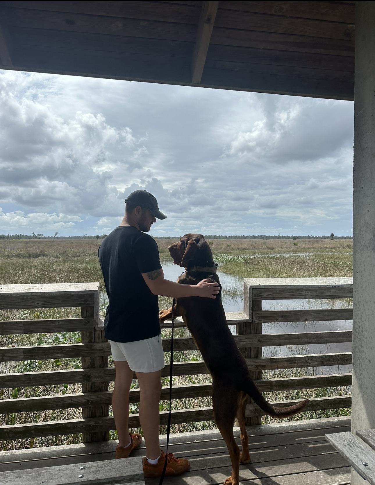 Chase Manney with his dog on a Treasure Coast boardwalk